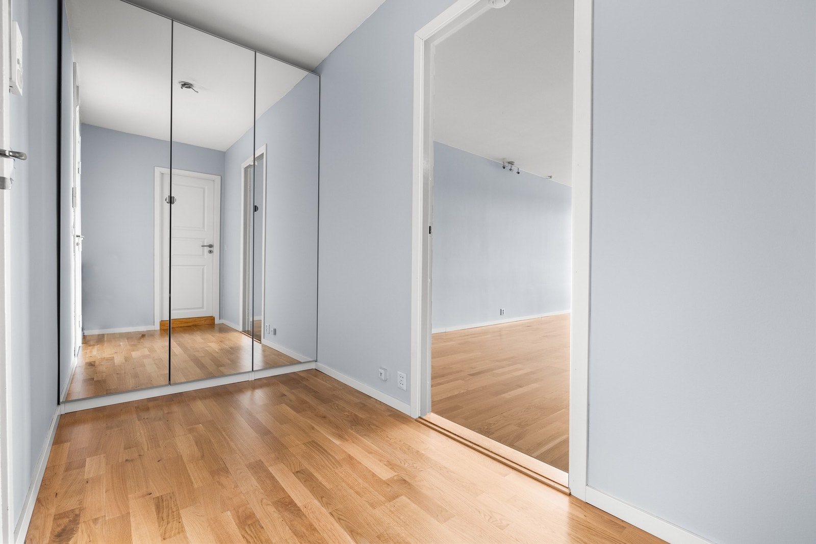 Romslig entre/hall med skyvedørsgarderobe Galleribilde