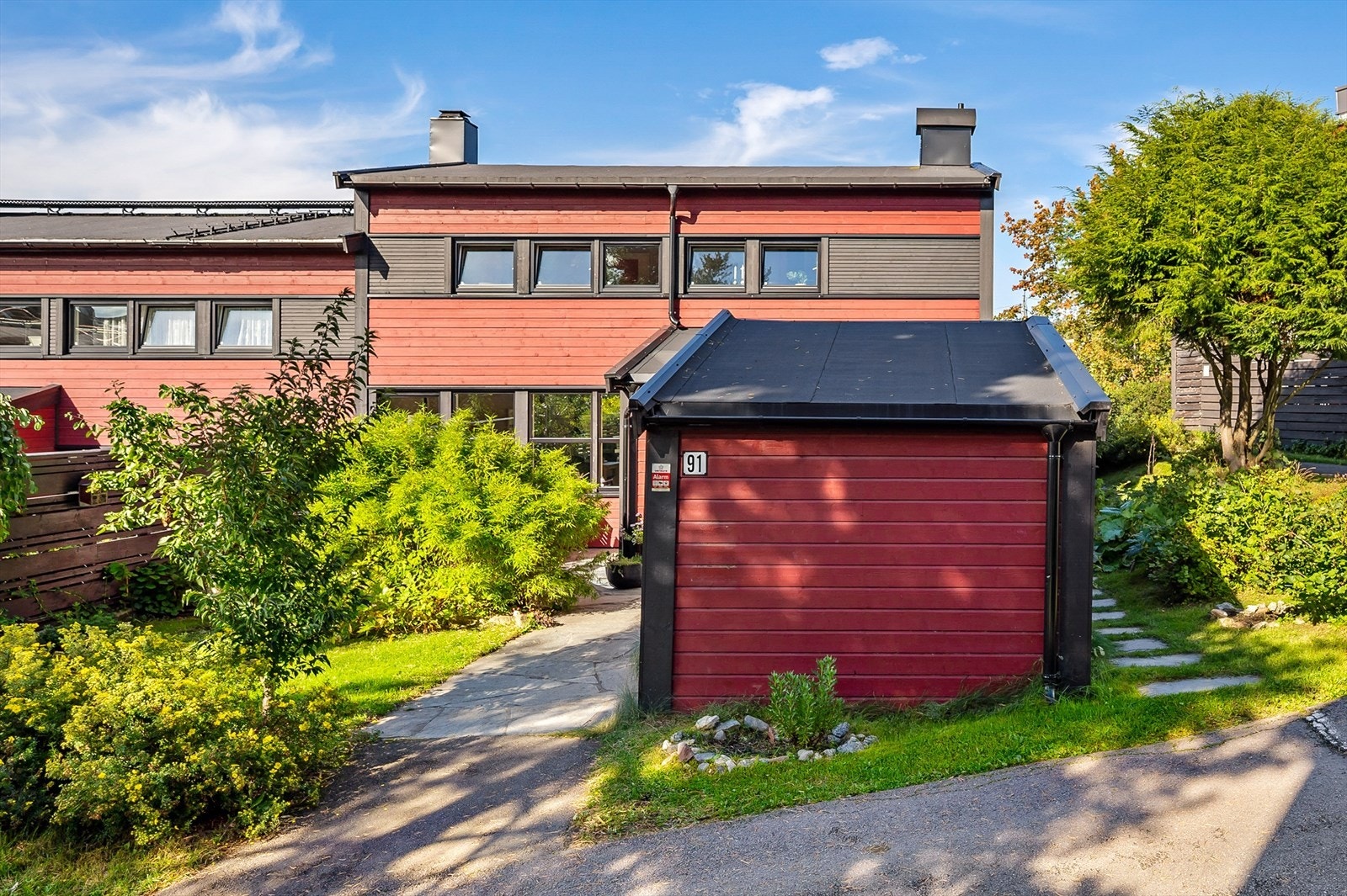 Flott rekkehus med pen fasade, utebod, stor terrasse og frodig hage. Attraktiv beliggenhet i rolig og barnevennlig nabolag. Galleribilde