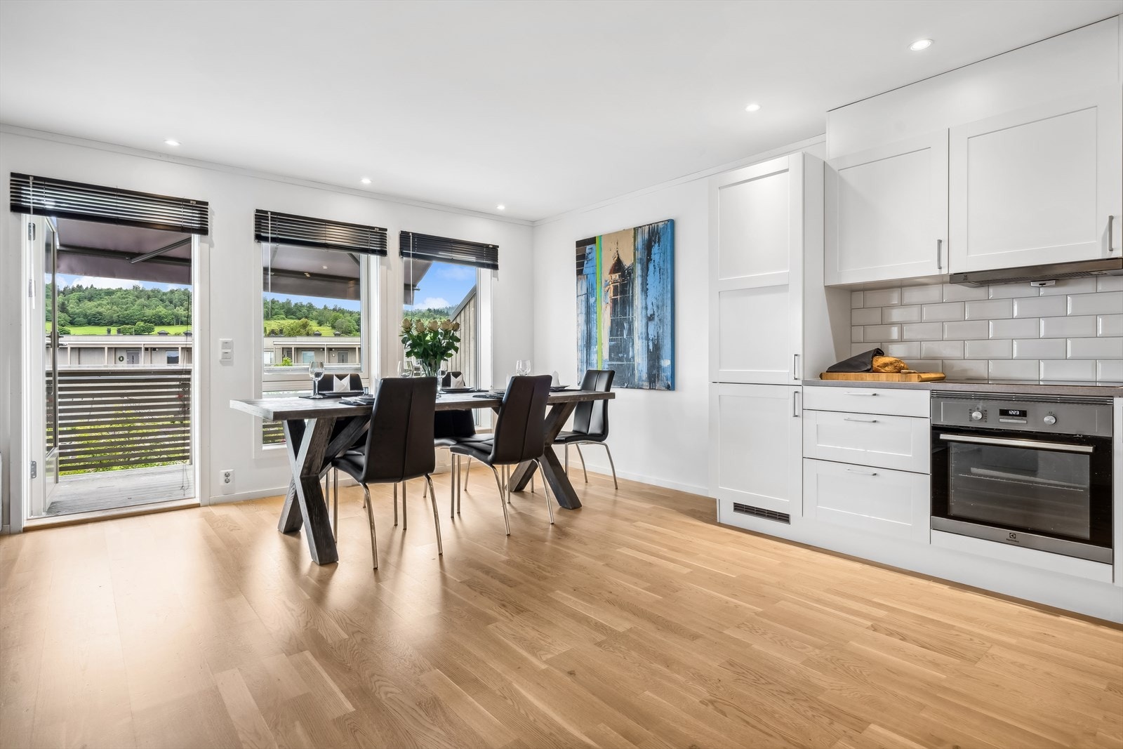 Lys spisestue med utstrakt bruk av downlights og direkte utgang til terrasse Galleribilde