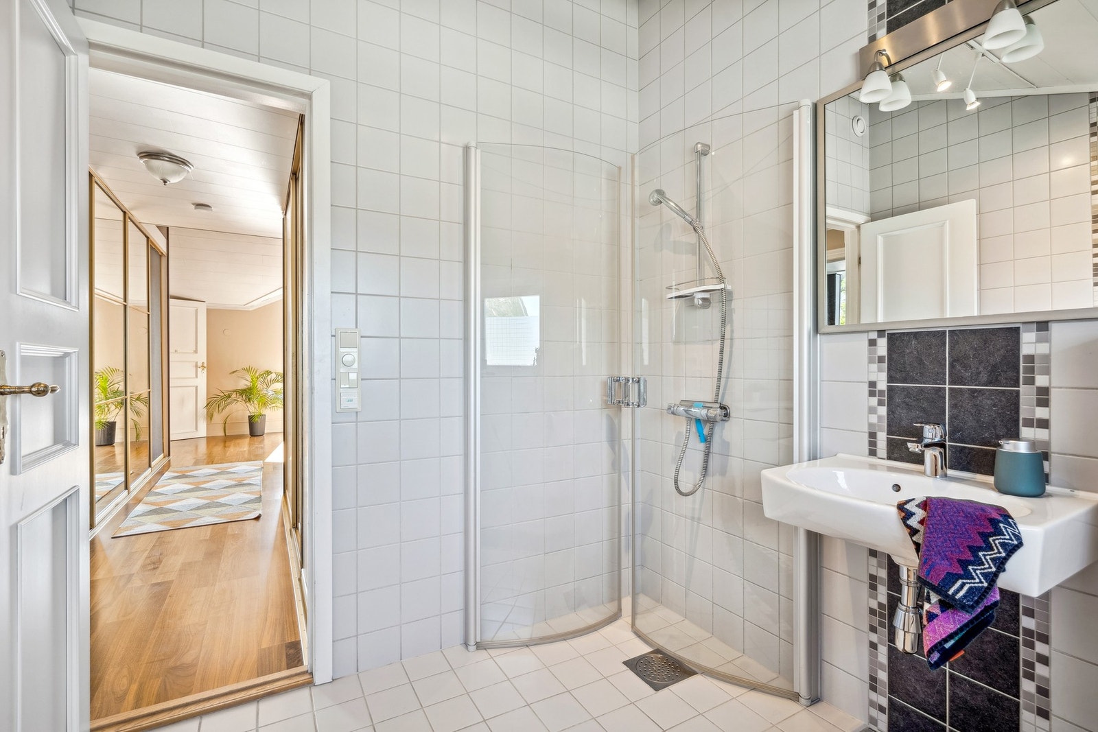 Det er innredet med servant, speil med belysning, WC og dusjnisje med innfellbare dører. Galleribilde