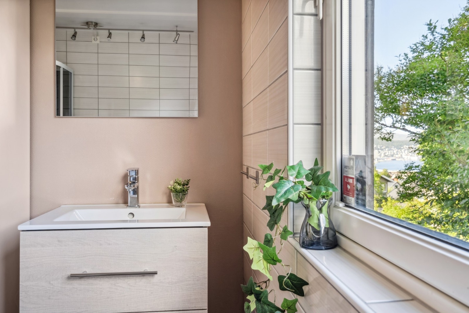 Badet inneholder en moderne innredning med nedfelt servant, dusjkabinett og WC. Galleribilde