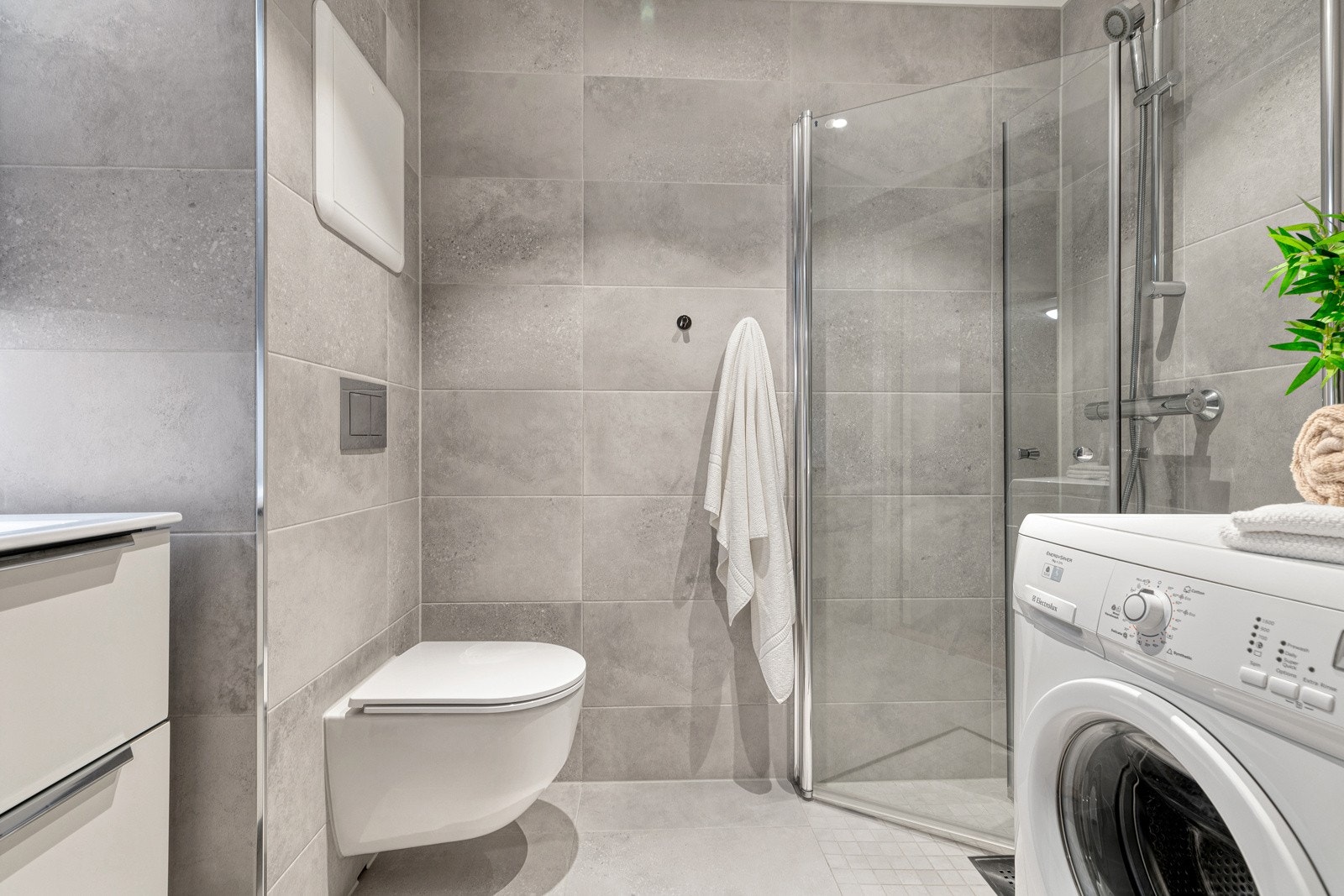 Delikat bad som er pusset opp i 2022 med fliser på vegg og gulv med gulvvarme Galleribilde