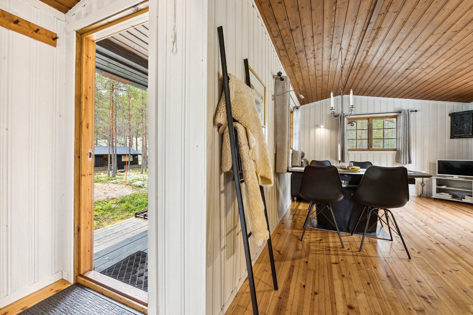 Her kommer du inn i en entré med hvitmalt panel på veggene og tregulv. Rommet er innredet med vegghengte knagger. Fra gangen har du adkomst til hygienerom rett frem og stuen på venstre side. Galleribilde