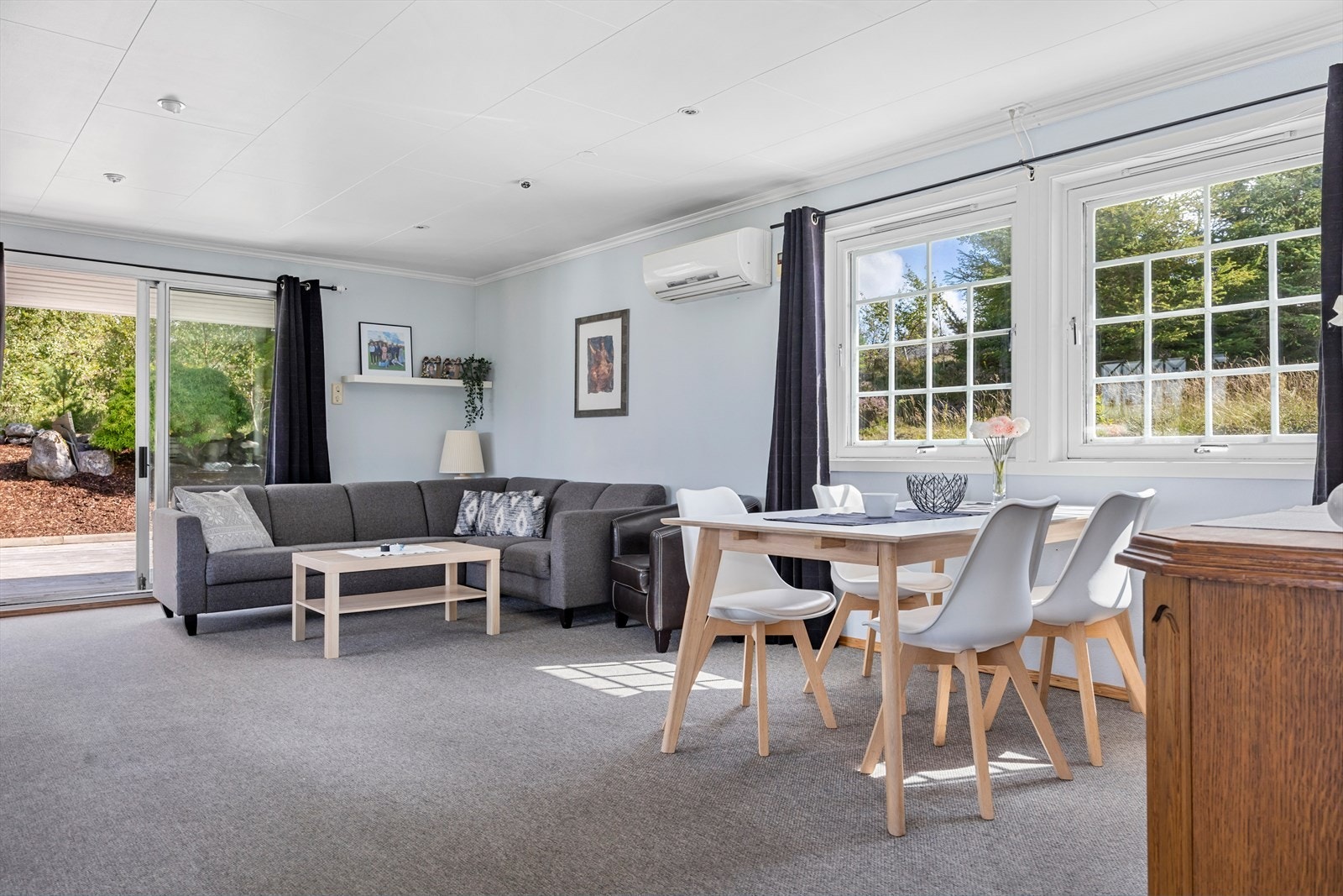 Romslig stue med plass til flere sittegrupper og spisebord, samt utgang til skjermet og solrik terrasse. Galleribilde