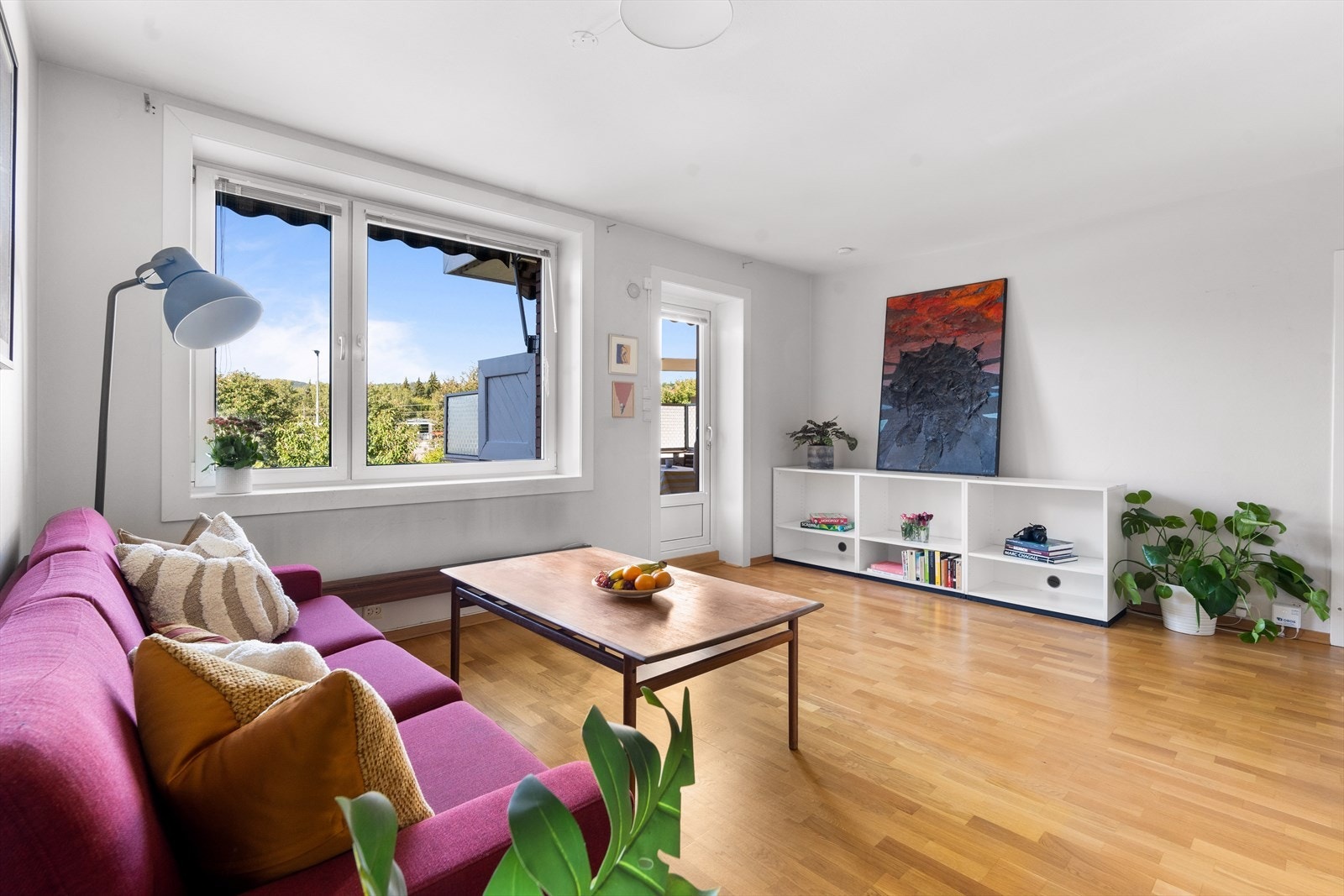 Leiligheten har en lys og luftig stue med store vindusflater som gir godt med lys inn i boligen Galleribilde