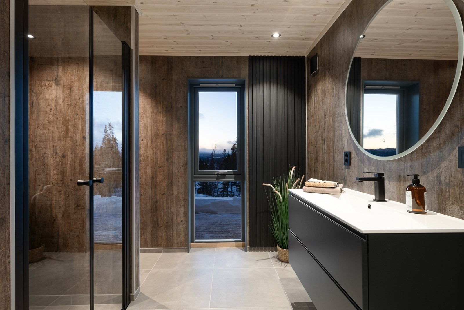 Badet har flislagt gulv med gulvvarme, baderomsplater på veggene og downlights i himlingen. Galleribilde