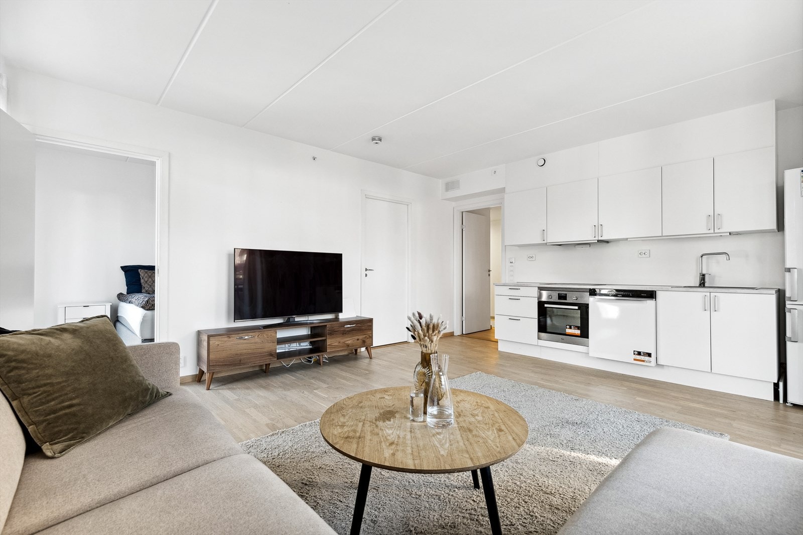 Hjørneløsningen og de store vinduene gjør stuen til et lyst og luftig oppholdsrom Galleribilde