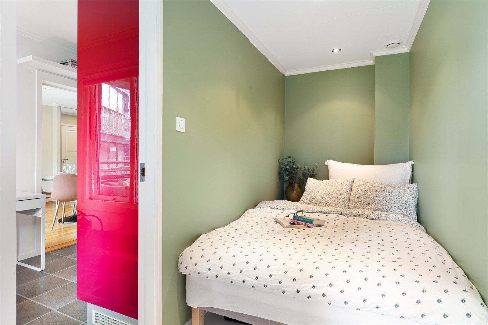 Soverom med plass til en dobbeltseng og utgang til en innglasset balkong Galleribilde