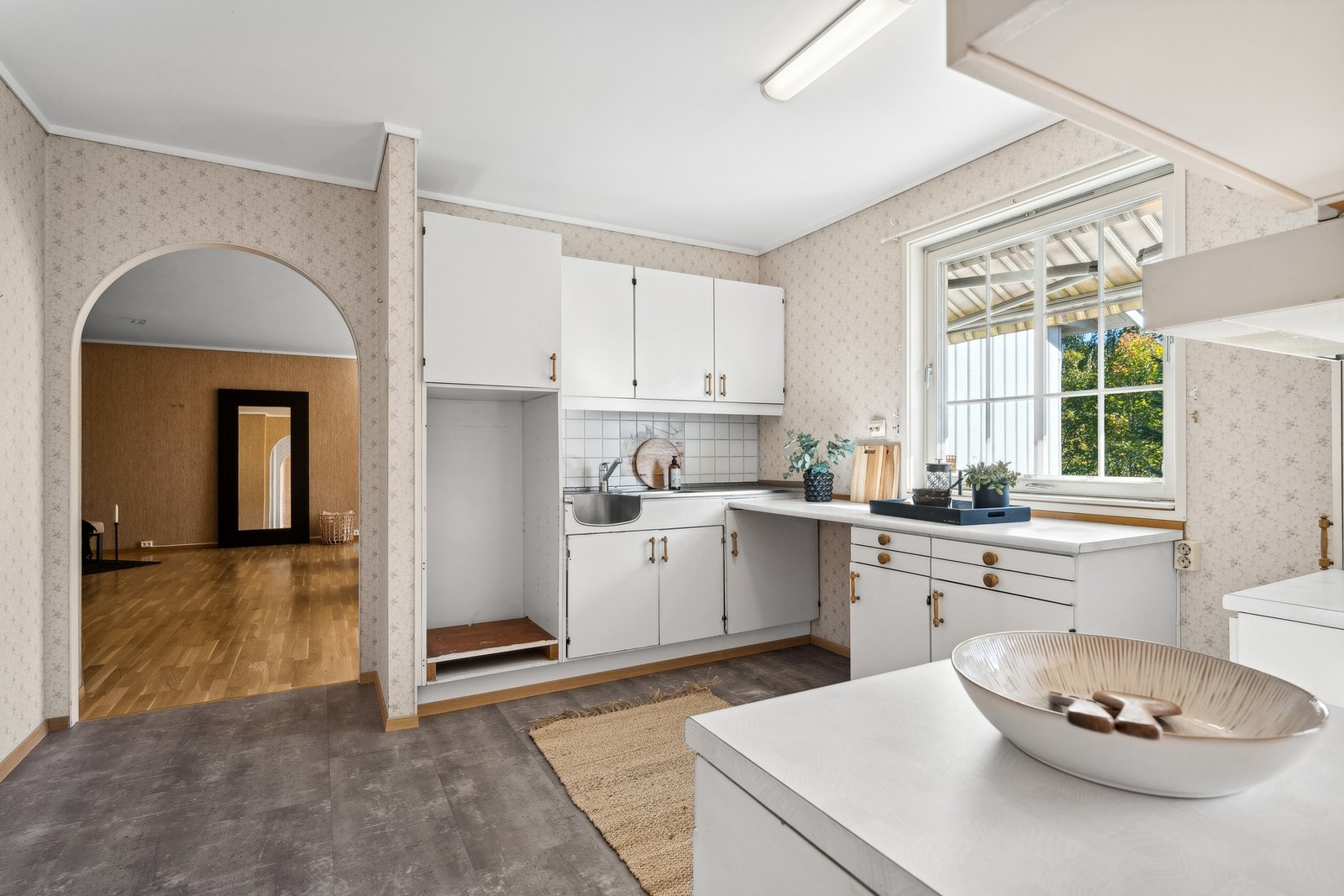 Lyst og romslig kjøkken med eldre innredning. Galleribilde