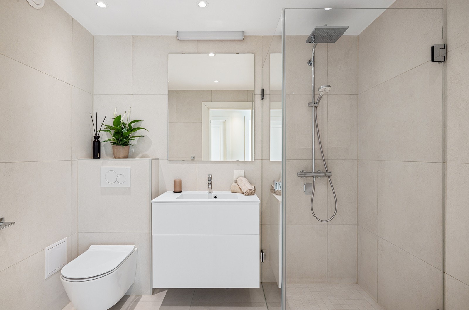 Badet er lekkert med vegghengt toalett og gulvvarme, og en dusjsone med regnfallsdusj og innfellbare dører. Galleribilde