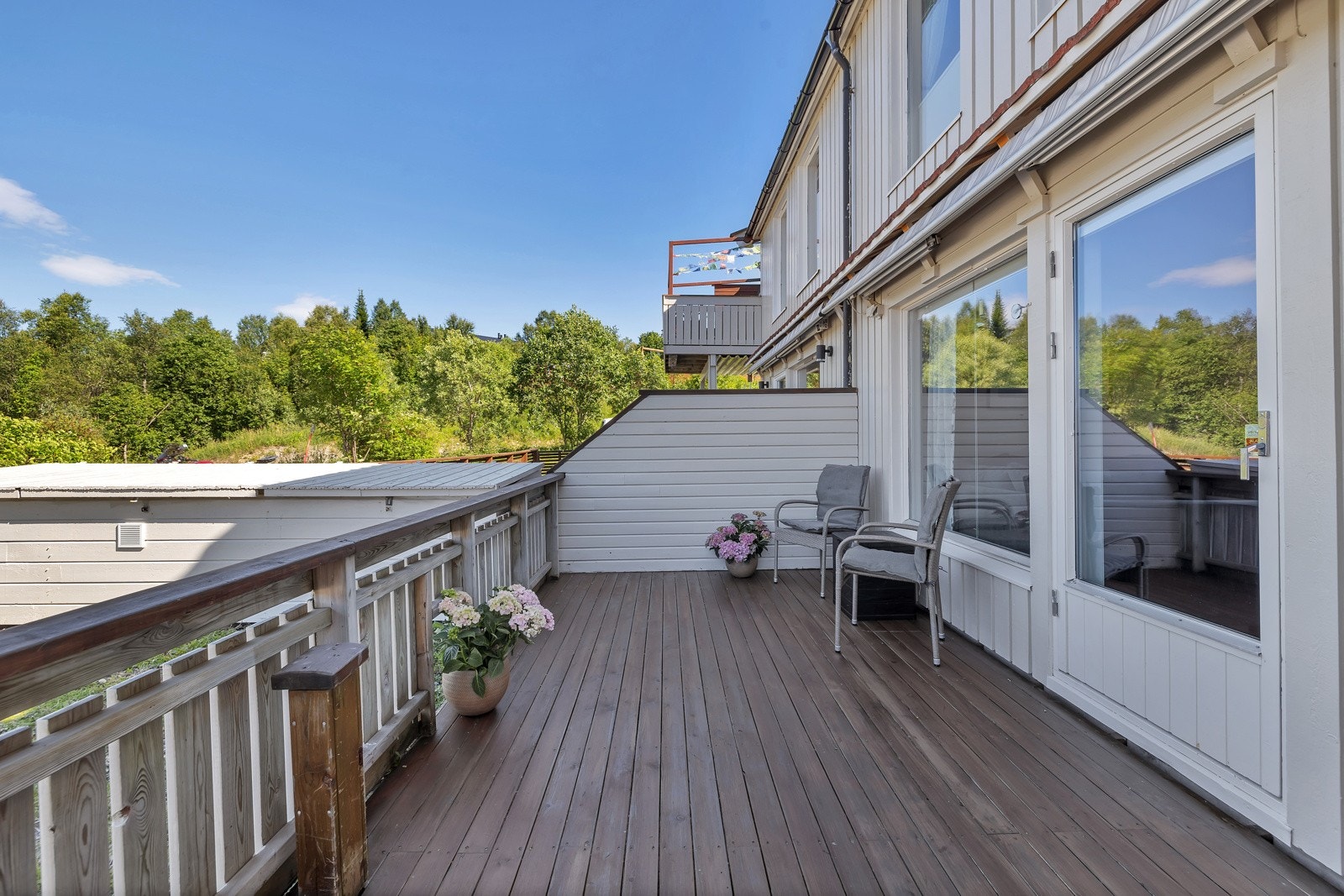 Terrassen rommer stort møblement og er delvis overbygget Galleribilde