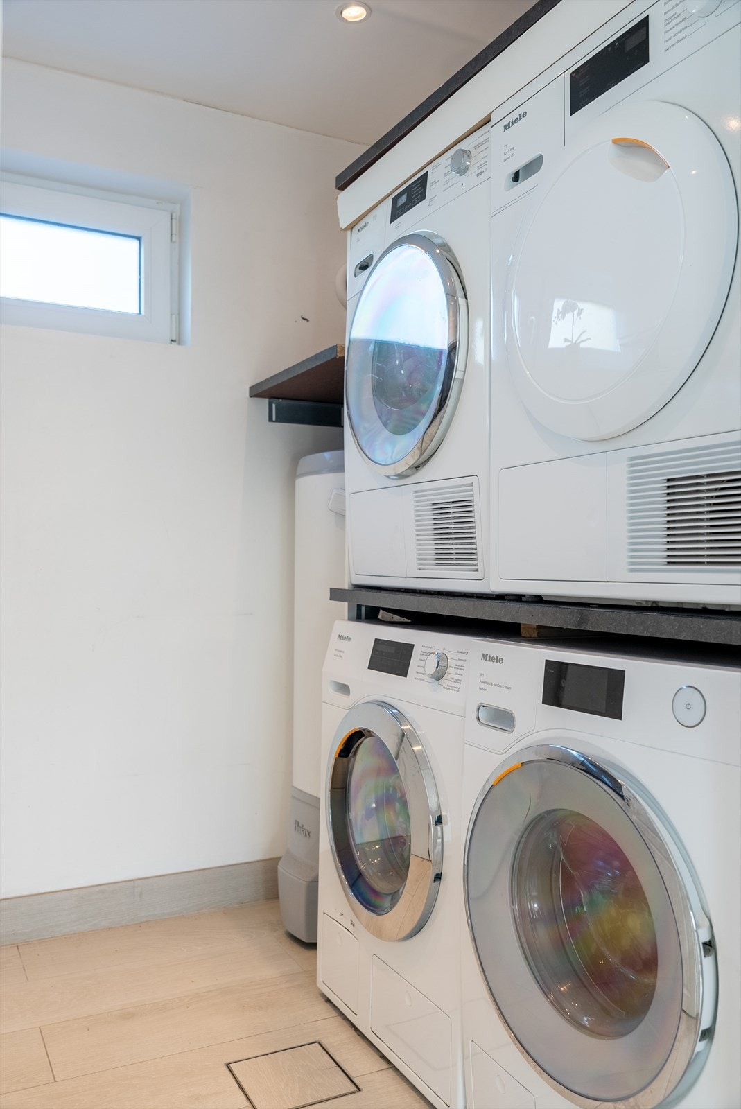 Praktisk vaskerom med plass til to vaskemaskiner og tørketromler. Dette gir fleksibilitet til å håndtere store mengder klesvask. Galleribilde