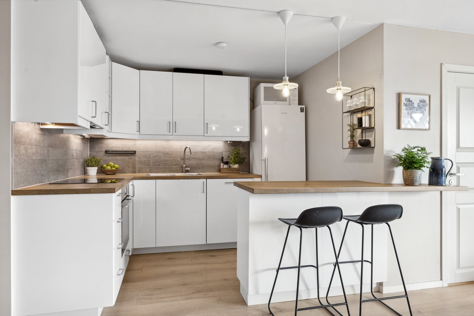 Lyst og fint kjøkken med integrerte hvitevarer som platetopp, ovn og oppvaskmaskin. Alle hvitevarer medfølger på kjøkken. Galleribilde