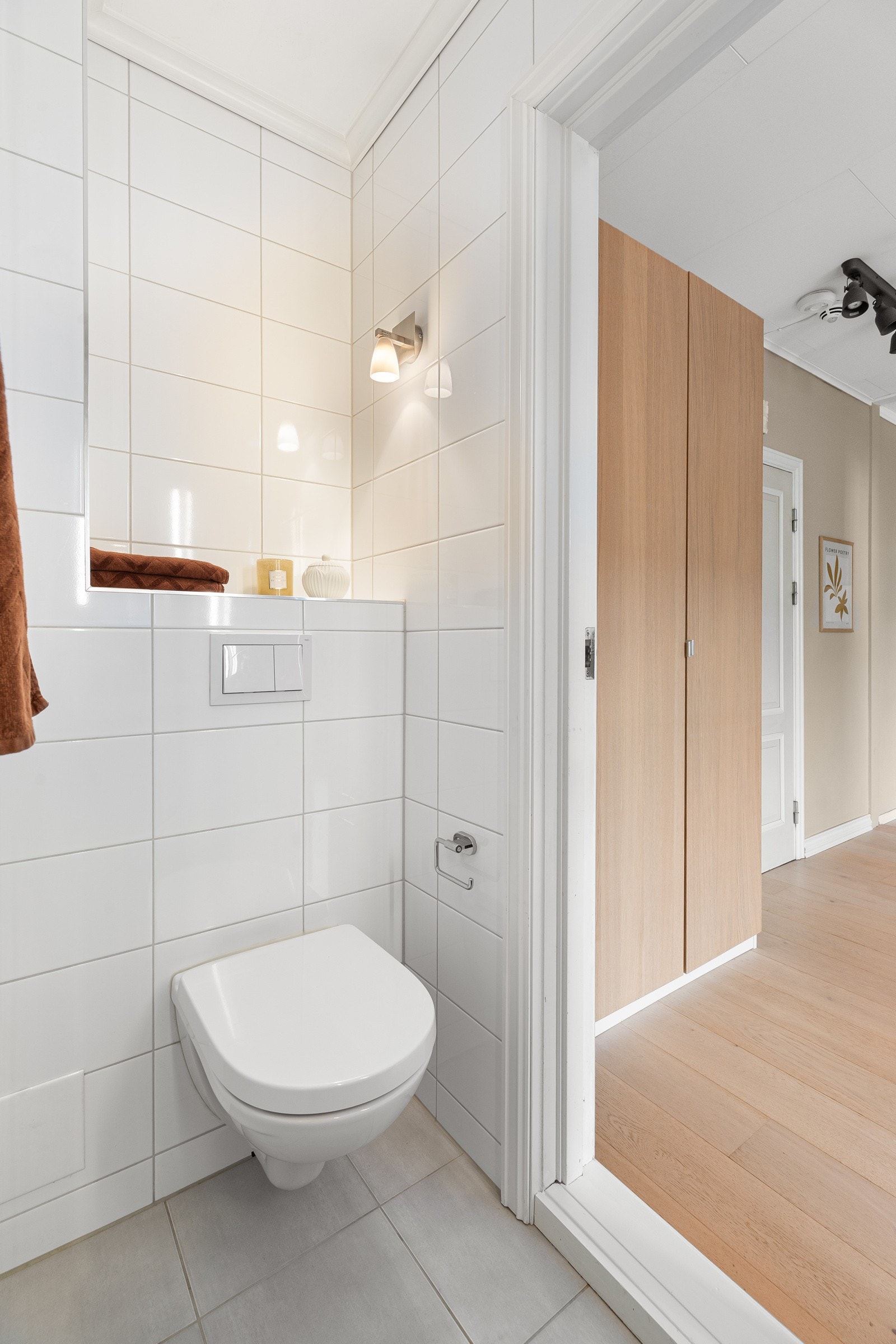 Moderne, vegghengt toalett og dusjhjørne med skyvedør. Fellesvaskeri i kjeller med vaskemaskin og tørketrommel Galleribilde