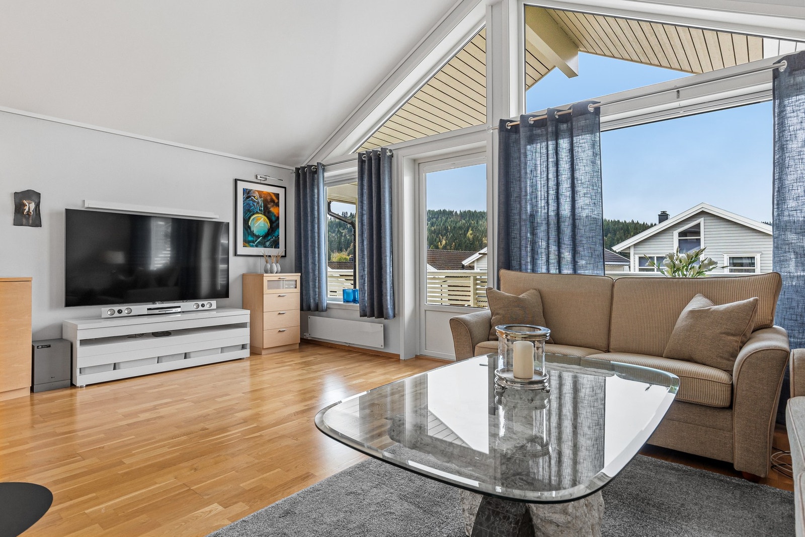 Stor og luftig stue på på 42,1 med store vindusflater og utgang til veranda. Galleribilde