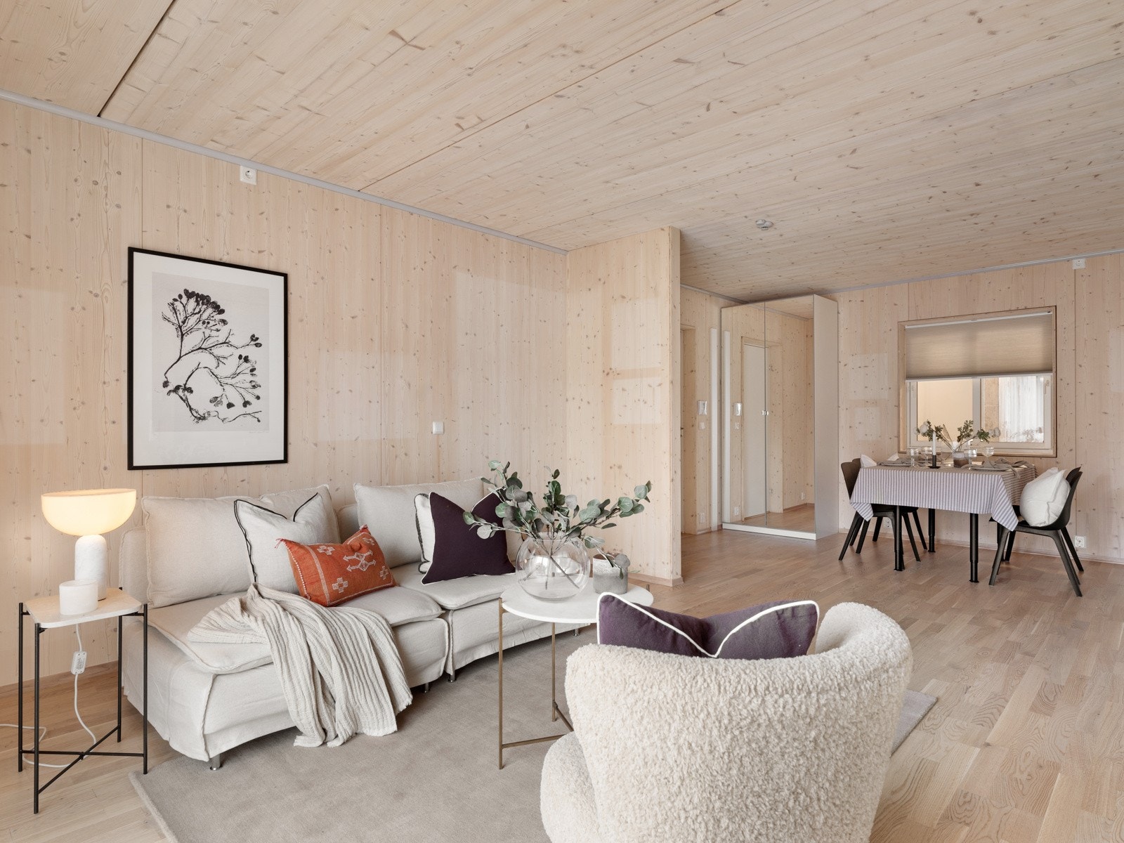 I rommet er det god plass til sofaløsning og spisebord, og ved ytterdøren er det montert garderobeskap med speildører. Galleribilde