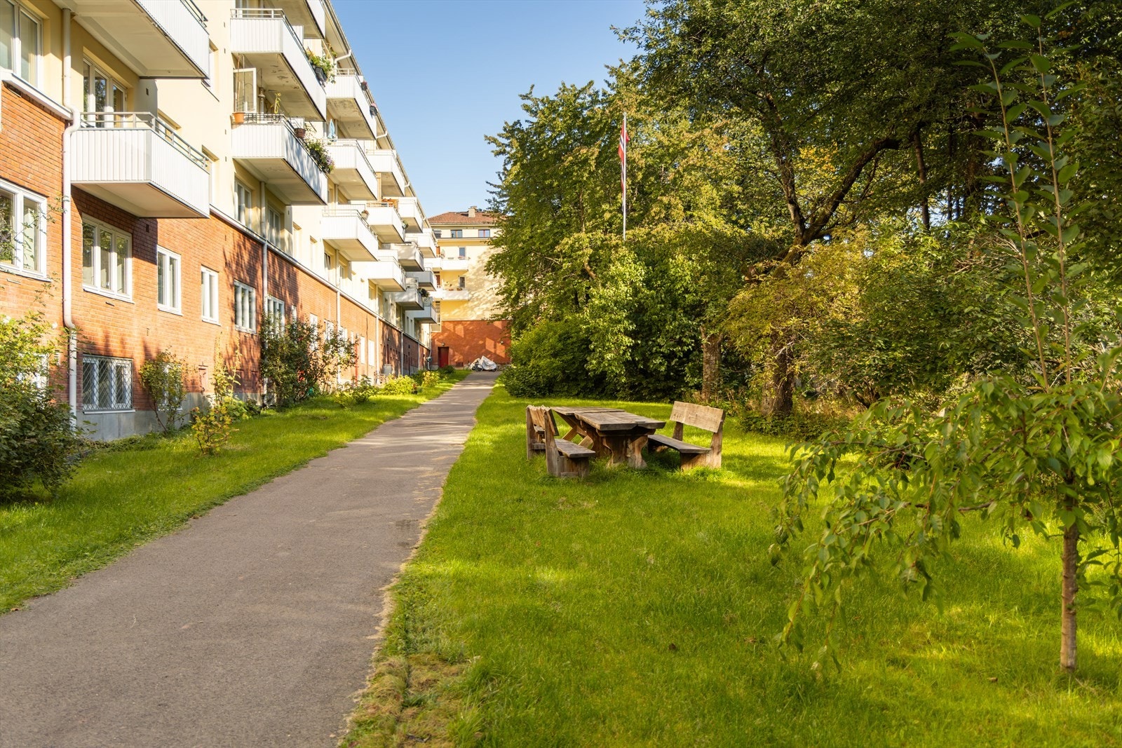 Boligen vender inn mot borettslagets vakre bakgård. Bakgården er pent opparbeidet med flere koselige sittegrupper, her finner du også hyggelig beplantning og bærbusker. Det er nylig plantet flere eple, pære- og plommetrær i hagen. Galleribilde