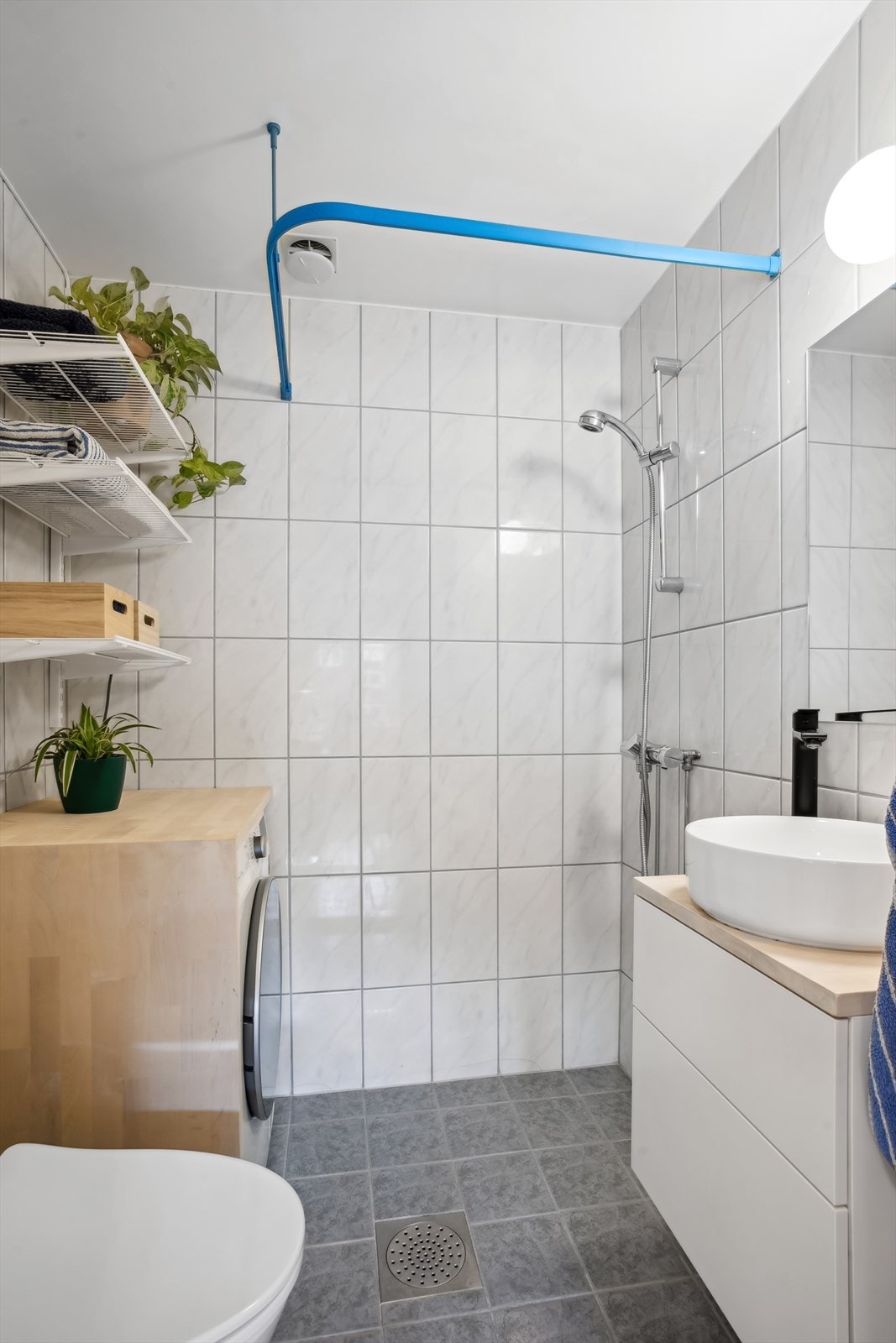 Badet har fliser på gulv og vegger, standard innredning, gulvvarme og dusjhjørne. Galleribilde