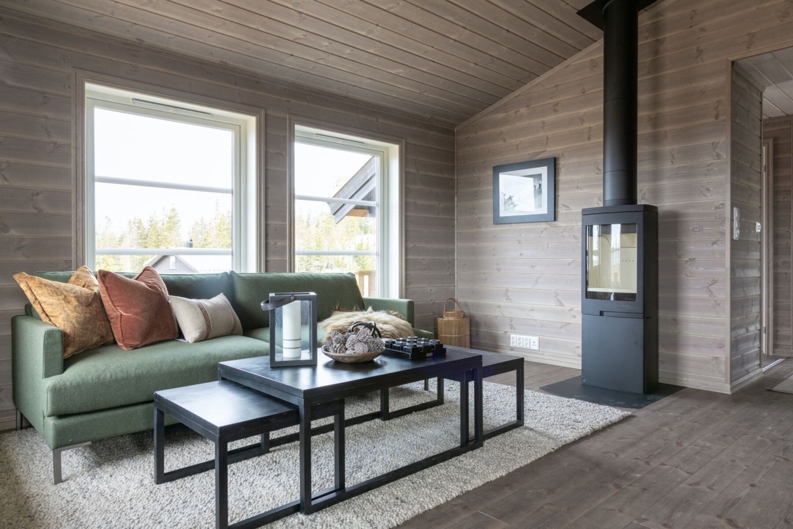 Foto fra stue i visningshytte. Peisovn medfølger i leveransen. Galleribilde