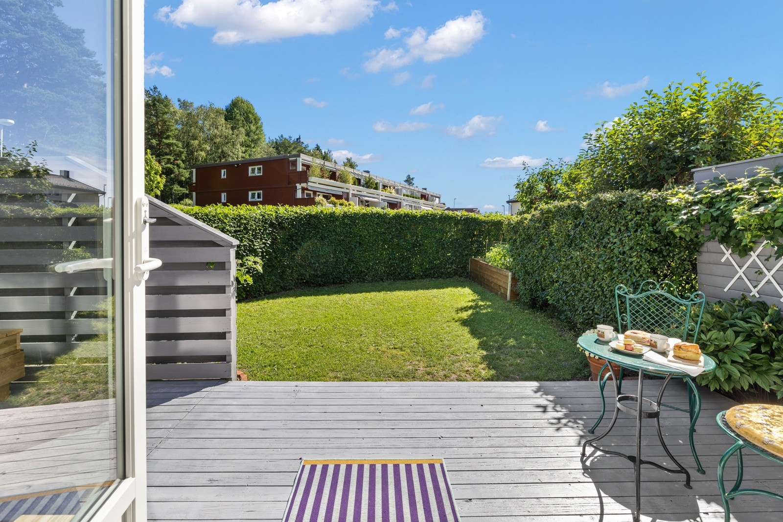 Adkomst fra stue til en sydvendt, solrik markterrasse med tregulv på ca. 19 m². Galleribilde