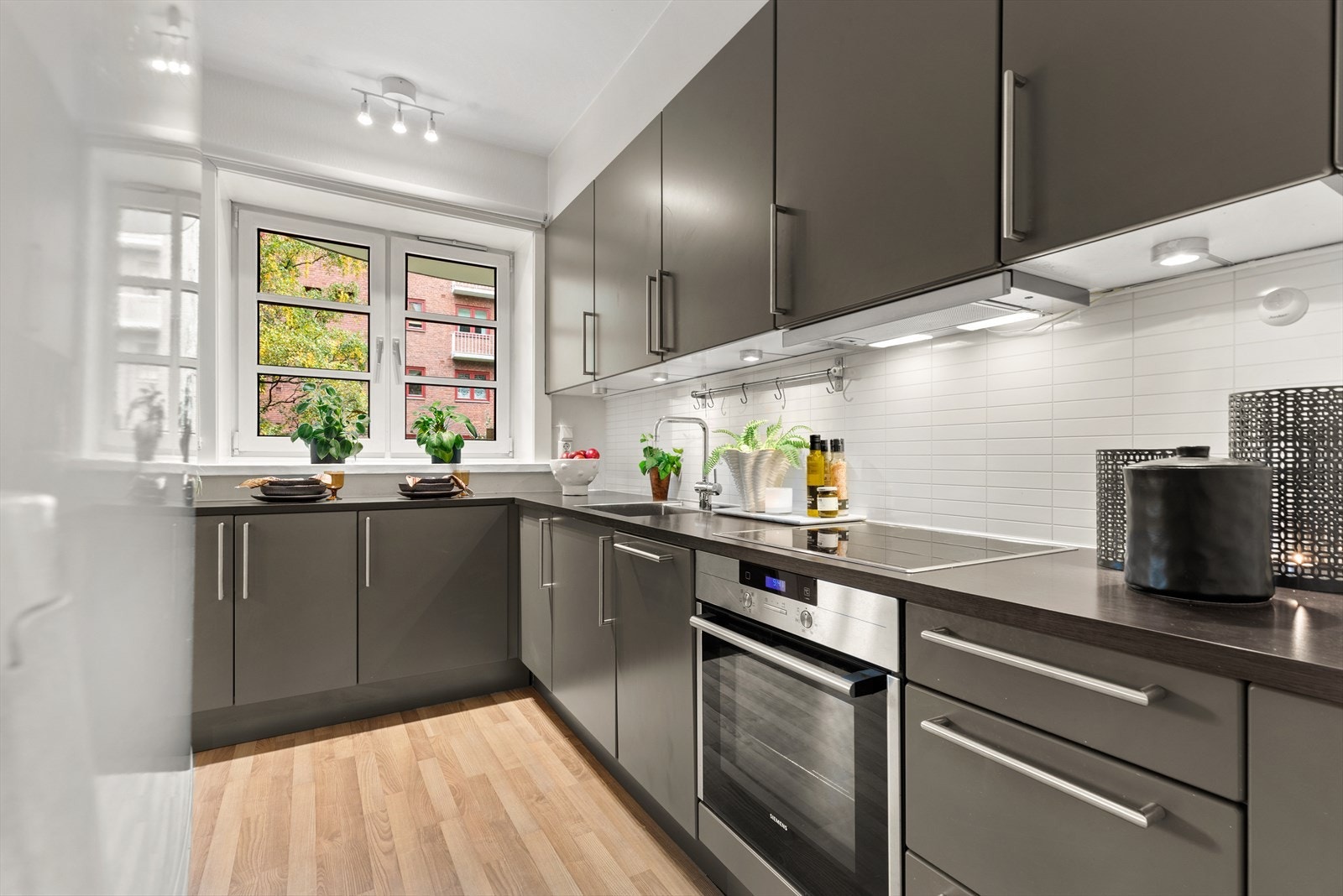 Kjøkkenet er utstyrt med integrert induksjonsplatetopp, stekeovn og oppvaskmaskin, samt plass til frittstående kjøle/fryseskKap Galleribilde