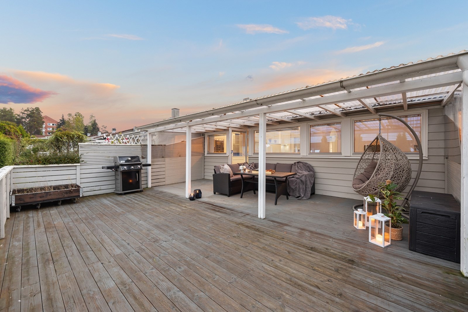 En stor og innbydende terrasse med flott utsikt, og en idyllisk atmosfære som skaper et ideelt sted for sommerdager og hyggelige kvelder Galleribilde