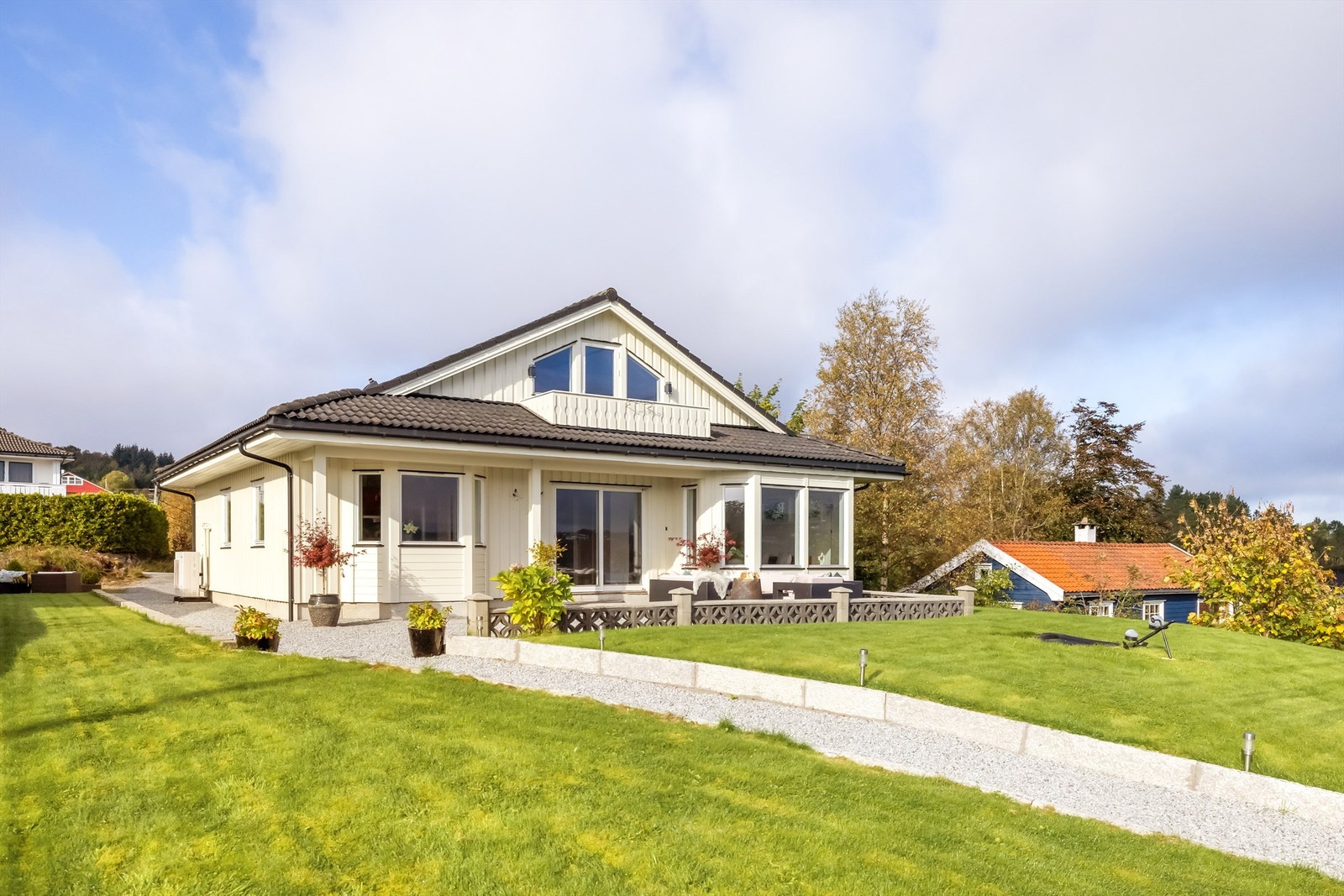 Et flott hus med store vindusflater, en pent opparbeidet tomt og hage som du blir glad i Galleribilde