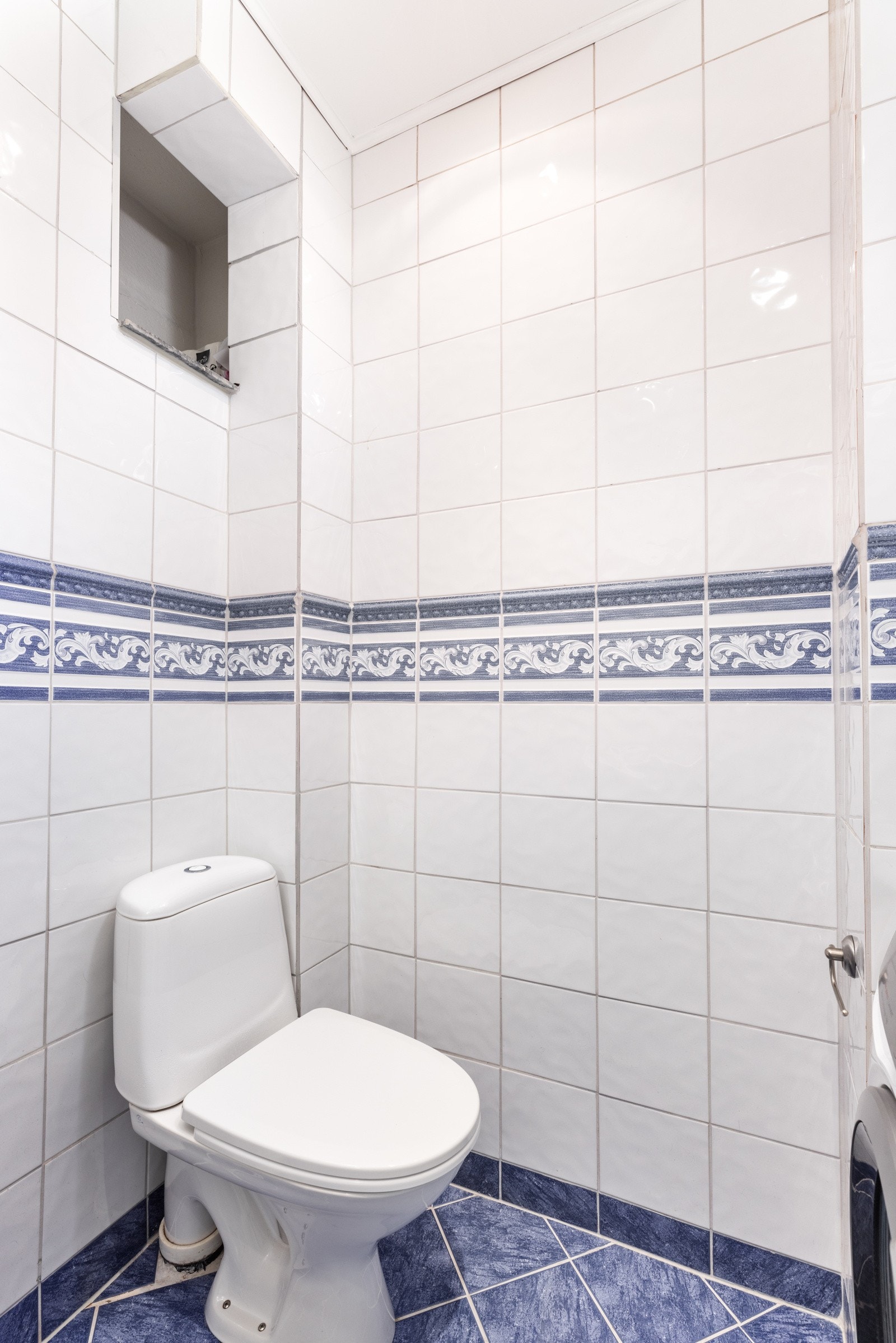 Badet er utstyrt med dusj, toalett, baderomsmøbel med servant og speil på veggen. Det er varmekabel i gulvet. Galleribilde