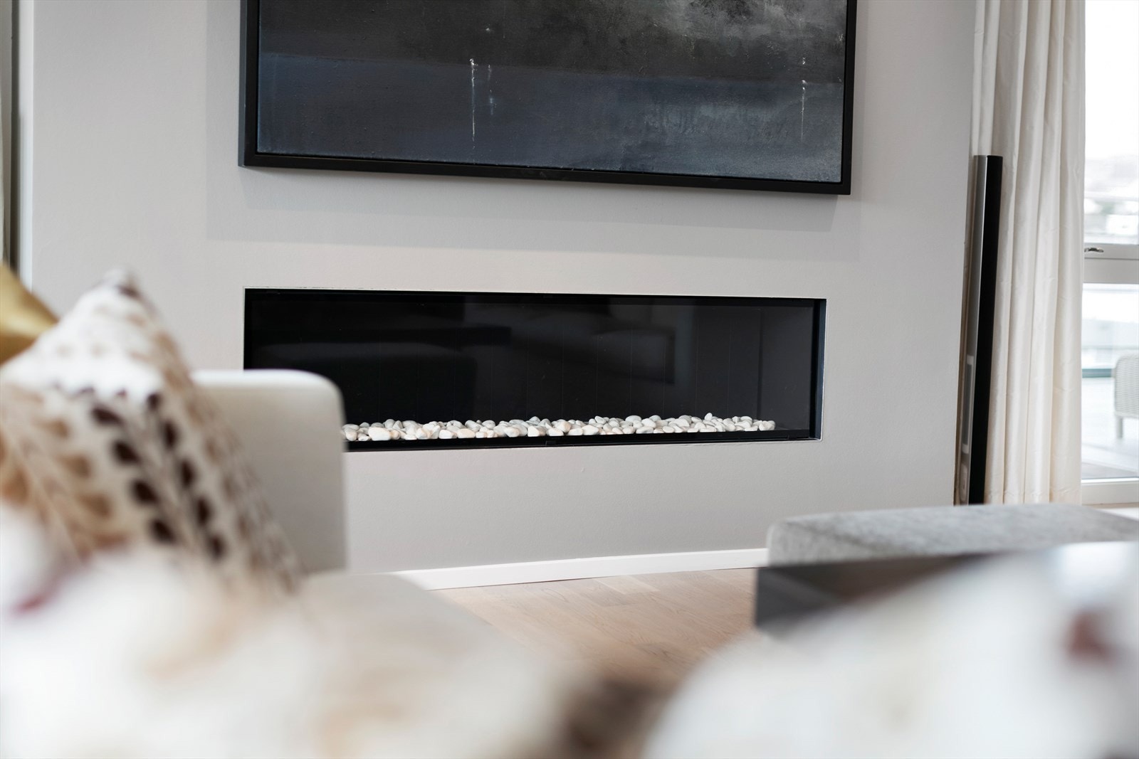 Det er vannbåren gulvvarme, gasspeis og ildsted i leiligheten Galleribilde