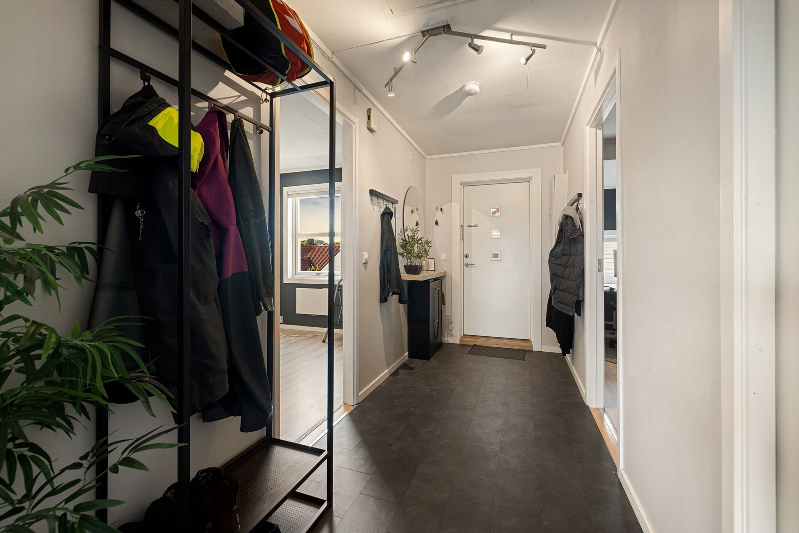 Vel inne blir vi ønsket velkommen i en pen entré med lysmalte vegger og grått flislaminat på gulvet. Her er det fin plass til knaggrekker, skohyller og klesskap. Galleribilde