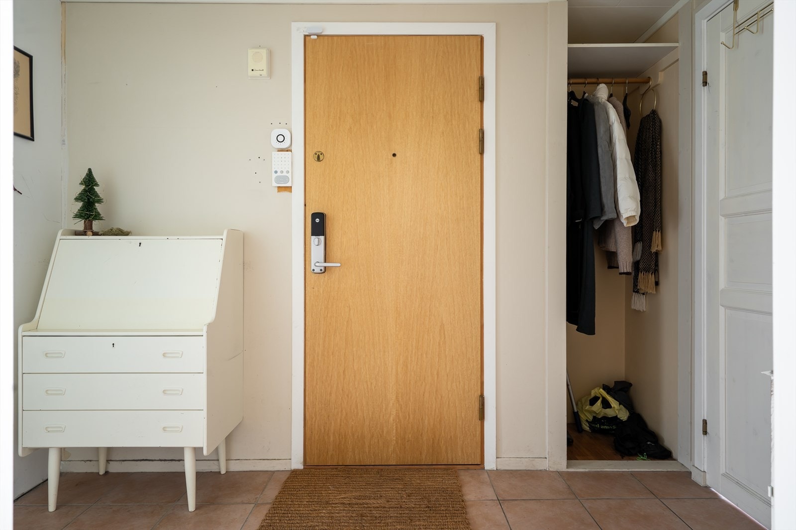 Velkommen inn til et romslig inngangsparti! Her kan jakker henges i en praktisk, åpen garderobe, mens det ellers er god plass til kommode, knagger og skohylle. Galleribilde