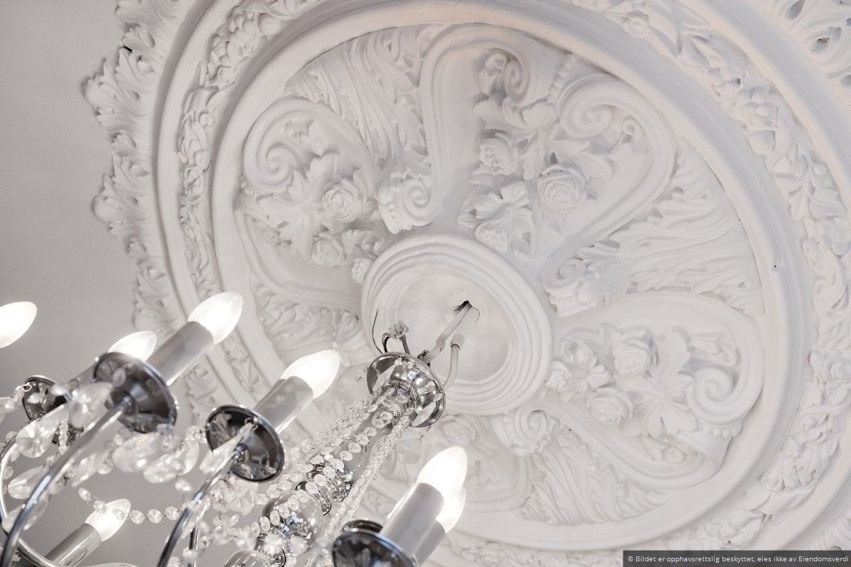 Dekorativ rosett i taket, som tilfører en sofistikert og tidløs stil. Galleribilde