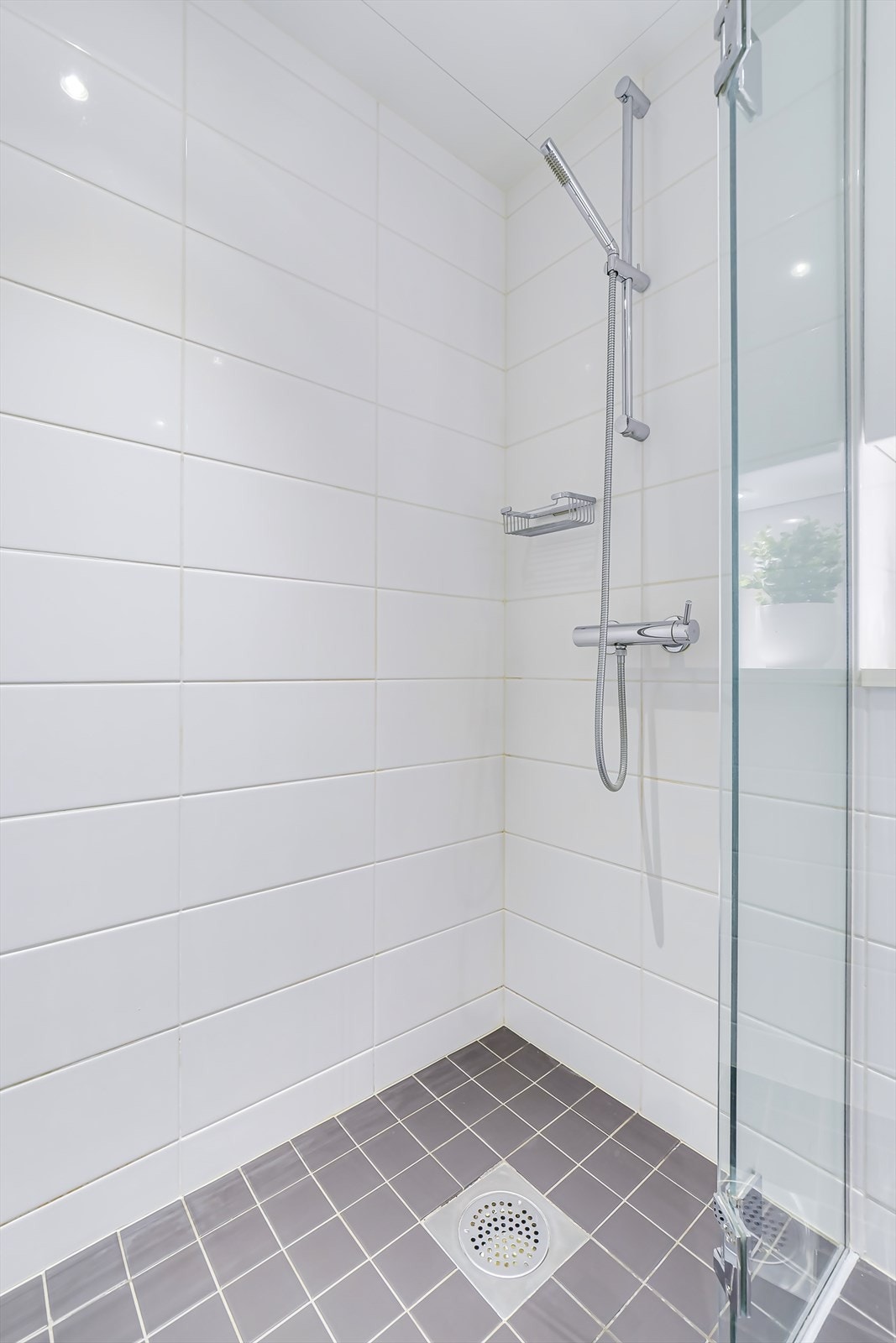 Badet har flislagte overflater og flislagt gulv med varmekabler Galleribilde