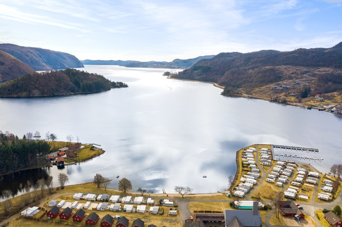 Ved Åpta camping innerst i fjorden, finner man en idyllisk sandstrand med egen flytebrygge. Galleribilde