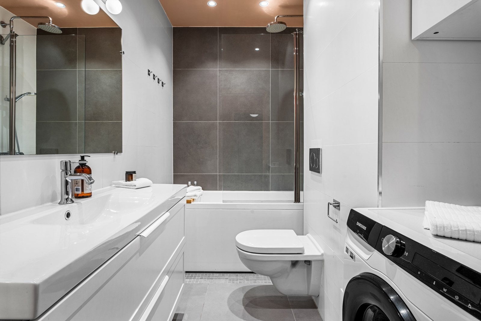 Delikat og innbydende bad med gulvvarme, downlights, badekar, vegghengt klosett m.m. Galleribilde