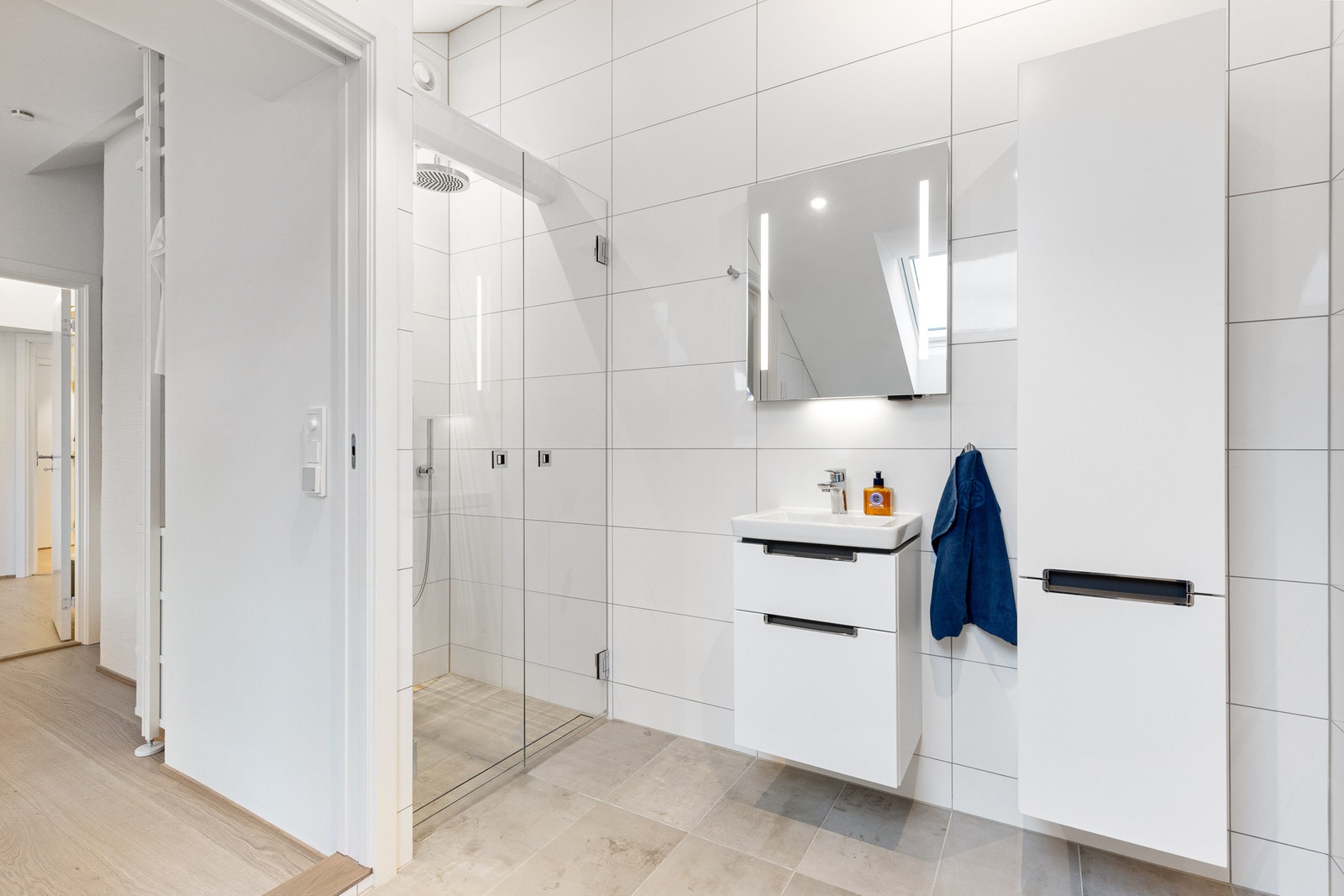 Flislagt baderom med varme i gulvet og naturlig lys fra takvindu. Galleribilde