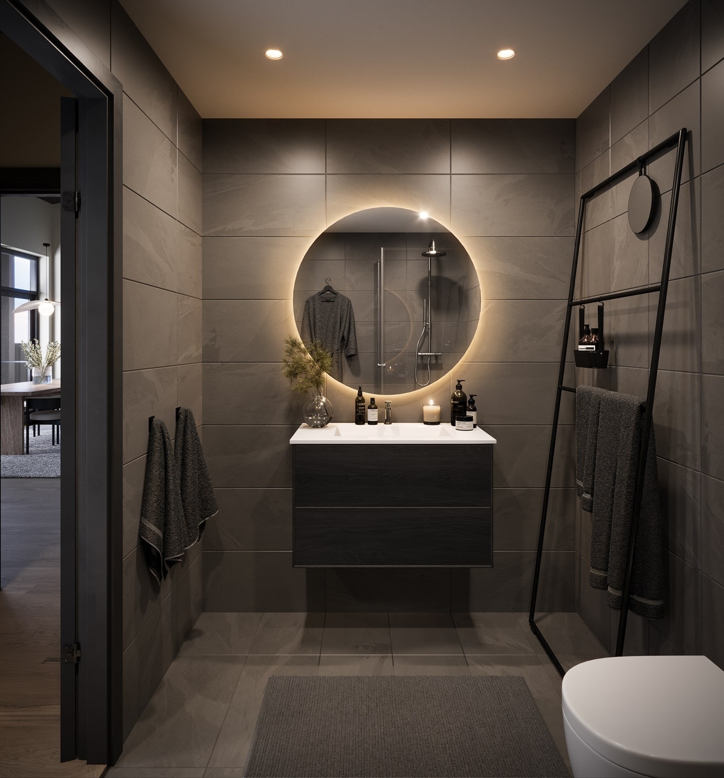 Baderommene har grå flis med skiferuttrykk og sort baderomsinnredning med trestruktur. Galleribilde