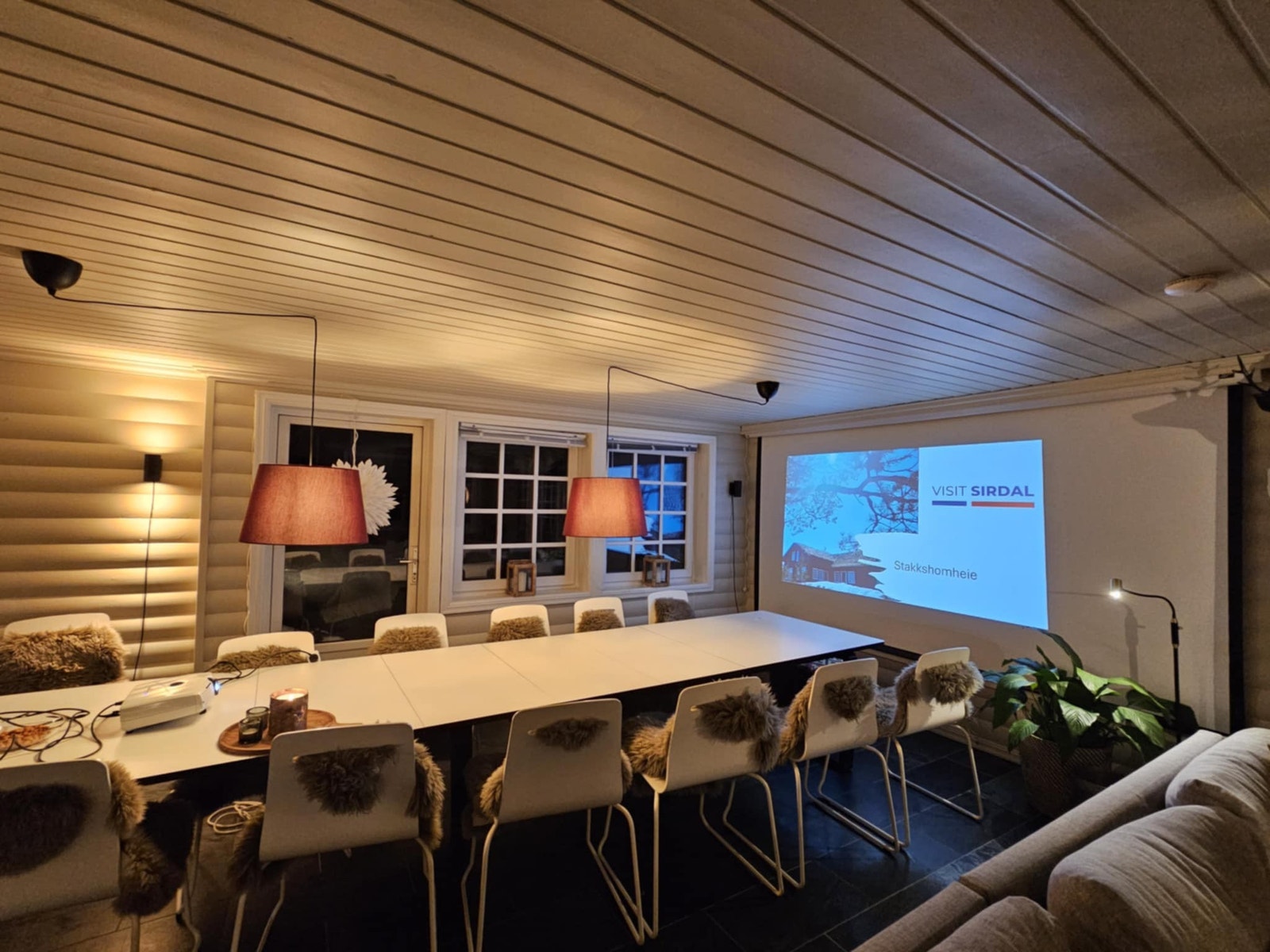 Langt spisebord med lerret som kan senkes ned fra taket Galleribilde