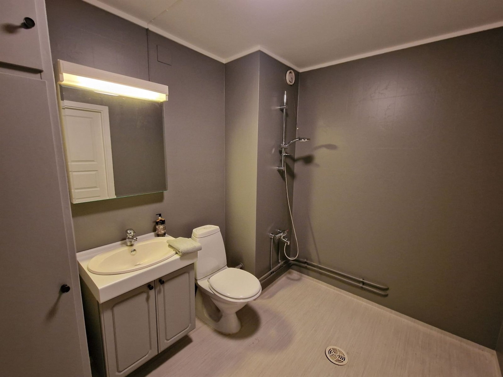 Badet er innredet med toalett, servantskap og vegghengt dusj. Opplegg/uttak for vaskemaskin. Galleribilde