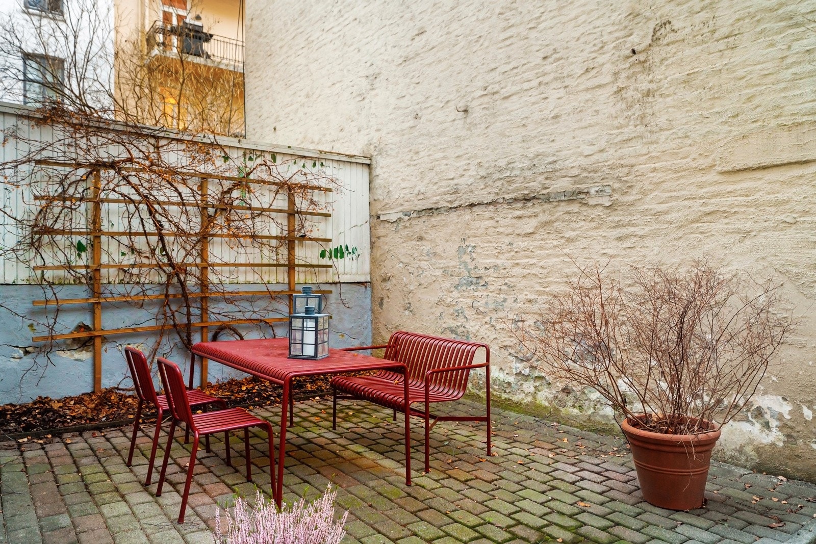 Skjermet gårdsrom med sittegruppe og dirverse beplantning. Galleribilde