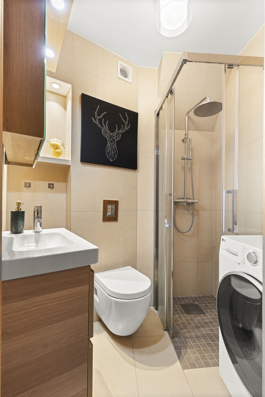 Dusjhjørne med vannfallsdusj og opplegg for vaskemaskin. Kombinert vaskemaskin/tørketrommel medfølger Galleribilde