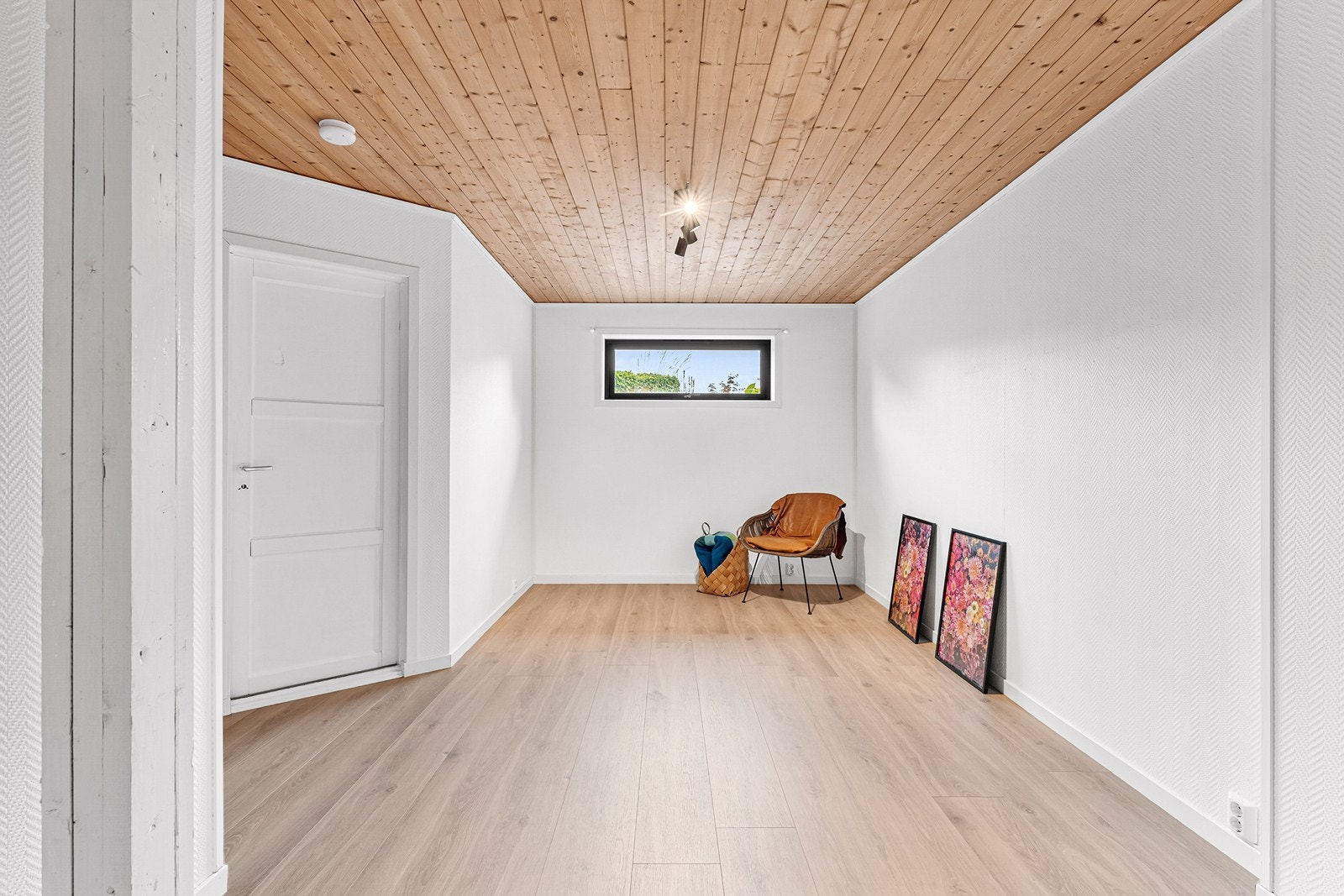 Praktisk kjellerstue med laminat på gulv og malte overflater på vegg. Galleribilde