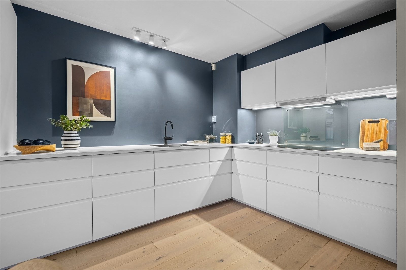 Utforming av kjøkkenet er gjennomført med god kombinasjon av over- og underskap for et luftig uttrykk Galleribilde