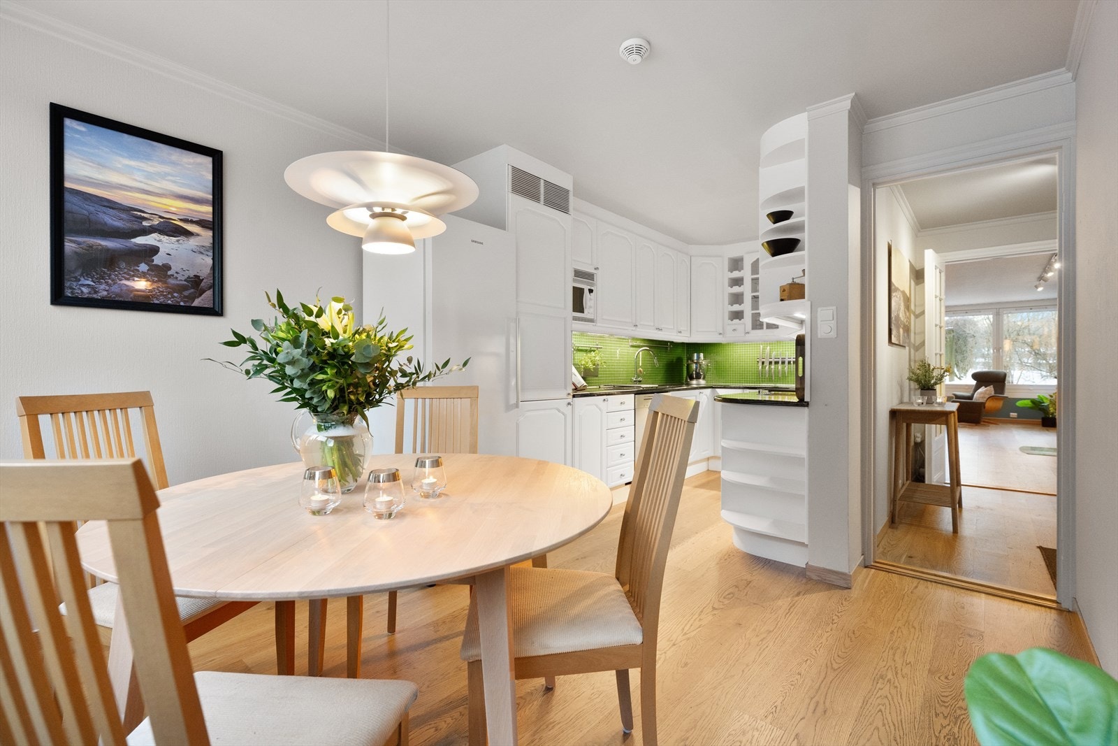 Boligen har et pent og innbydende kjøkken med plass til spisebord. Her er det rikelig med skuffer, skap- og benkeplass. Galleribilde