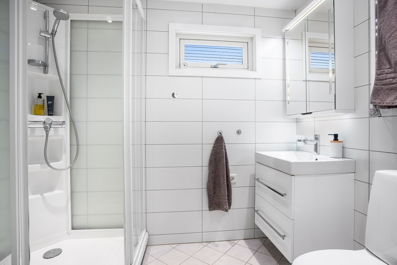 Bad med adkomst fra vaskerom ble pusset opp i 2013. Badet er utstyrt med en nedfelt servant, gulvfestet toalett og dusjkabinett. Galleribilde