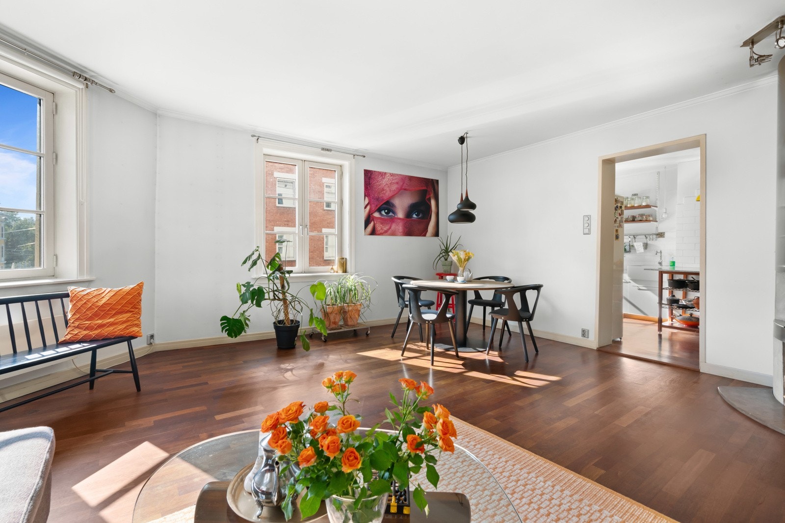 De lysmalte veggene fremhever det gylne parkettgulvet, i det ene hjørnet er det en stor, platekledd og åpen peis. Galleribilde