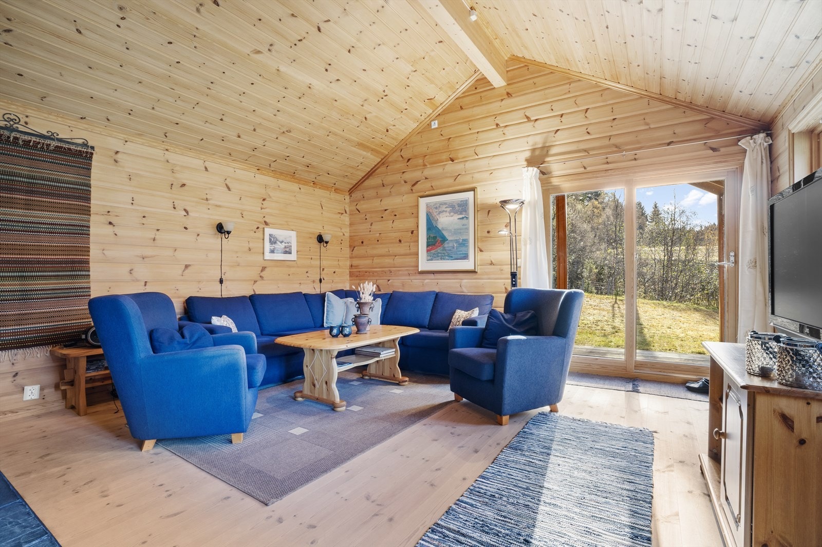 Stuen fremstår som et lyst og romslig oppholdsrom med flott takhøyde som gir en luftig og åpen følelse Galleribilde