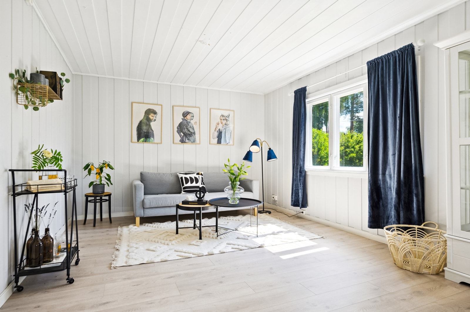 Lys og romslig stue med den opprinnelige og sjarmerende panelene på vegger og i himling. To vegger i stua er malt i kontrast farge etter at bildet ble tatt. Galleribilde