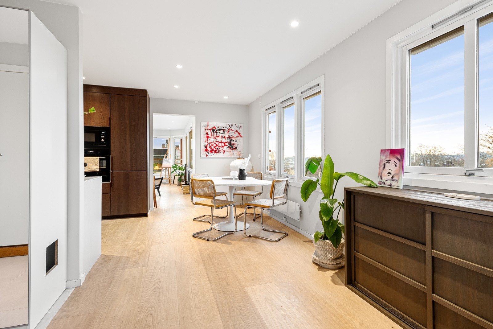 Sosial kjøkkenløsning med spisebord plassert ved vindusflater som gir gode lysforhold og flott utsyn. Galleribilde