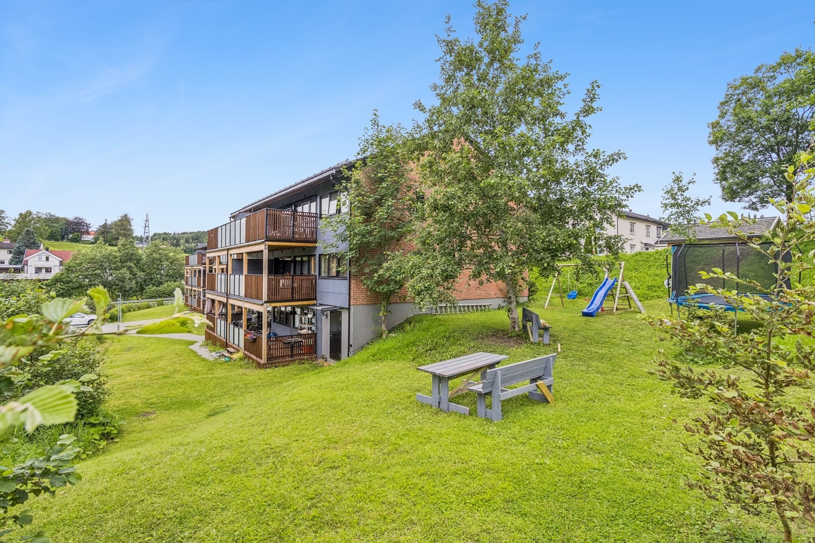 Borettslagets fellesområde består av blant annet av gressplen, lekeområde, sittegrupper og asfaltert parkeringsplass. Galleribilde
